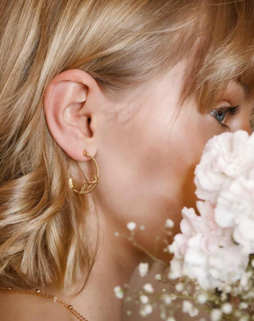 Gold hoop earring worn with loose hair