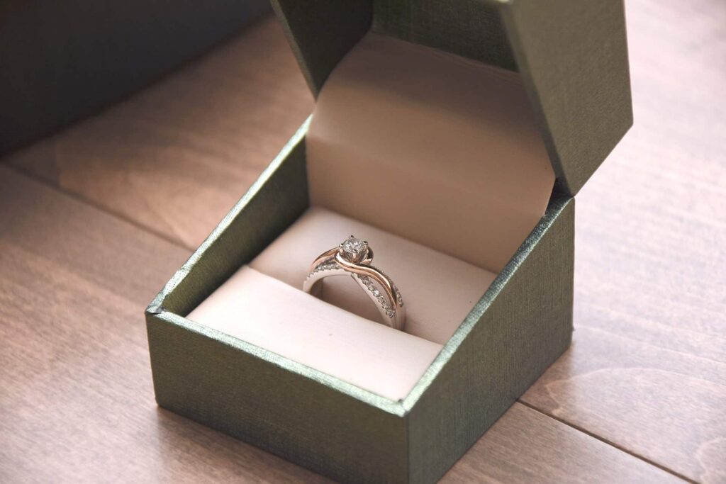 A ring presented in an open green jewelry box