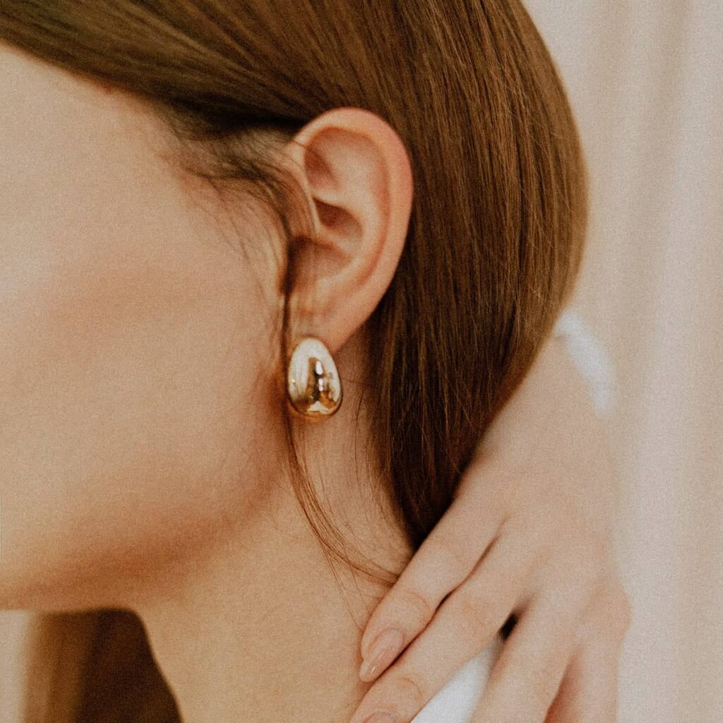 Close-up of a gold drop earring